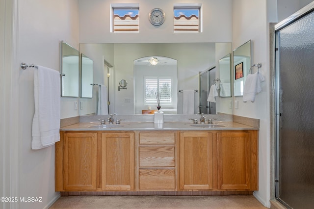 bathroom with an enclosed shower, vanity, and ceiling fan