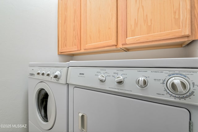 laundry room featuring cabinets and independent washer and dryer