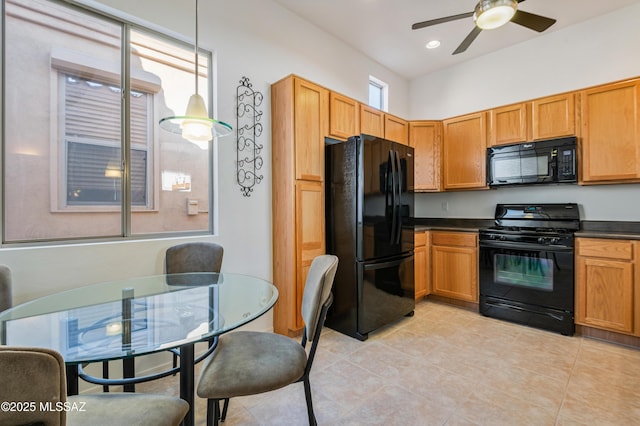 kitchen with light tile patterned floors, ceiling fan, black appliances, and hanging light fixtures