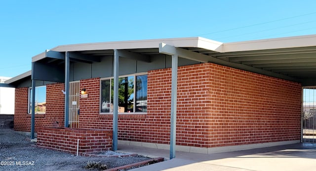 view of side of home with a carport