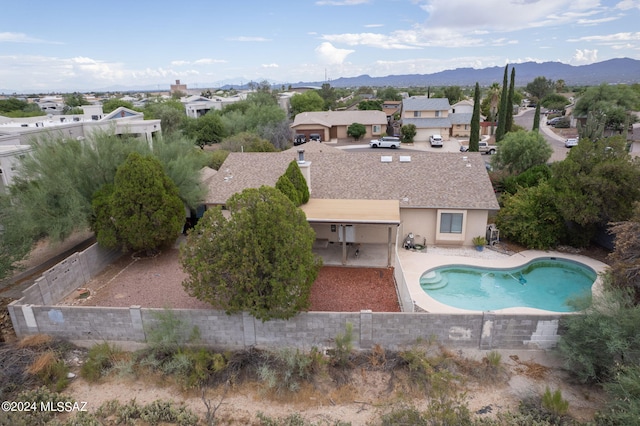 view of swimming pool featuring a patio area and a mountain view