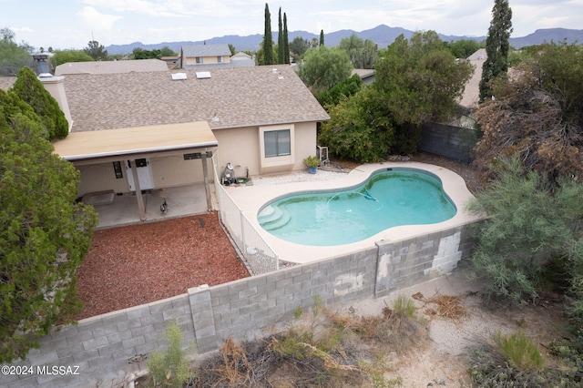 view of pool with a mountain view and a patio area