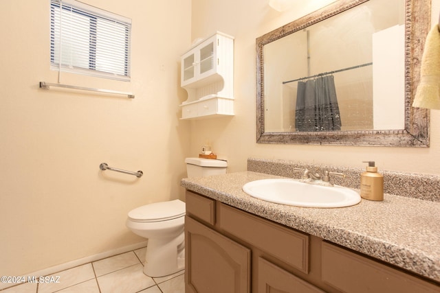 bathroom featuring toilet, a shower with curtain, tile patterned floors, and vanity