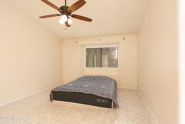 tiled bedroom featuring ceiling fan