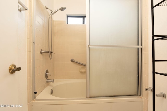 bathroom with shower / bath combination with glass door