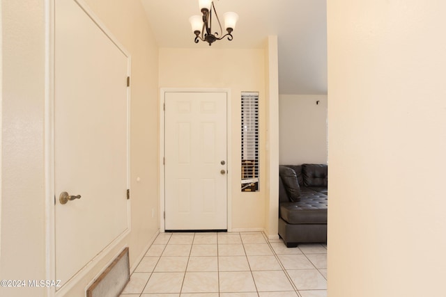 tiled entryway with an inviting chandelier