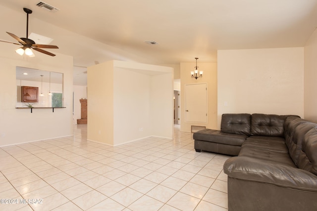 living room with ceiling fan with notable chandelier and light tile patterned floors