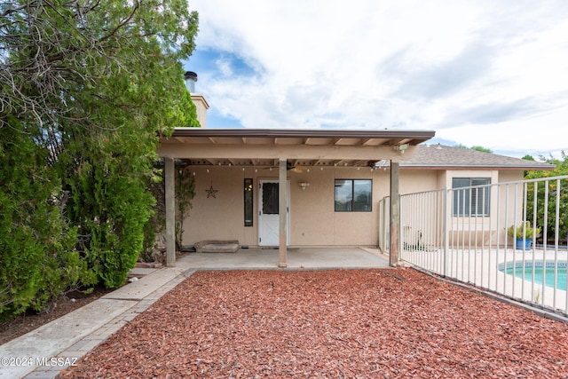 rear view of house featuring a patio area and ceiling fan