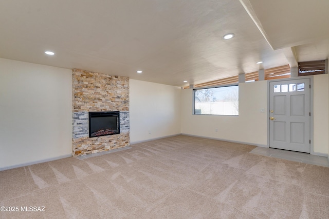 unfurnished living room featuring light colored carpet and a fireplace