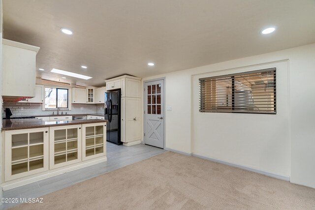 empty room with baseboards, recessed lighting, and light colored carpet