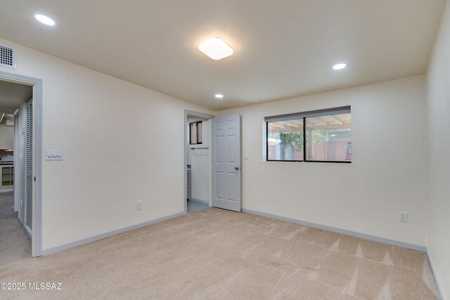 empty room with recessed lighting, baseboards, and light carpet