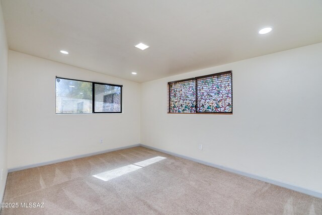 unfurnished bedroom with light carpet, visible vents, and recessed lighting