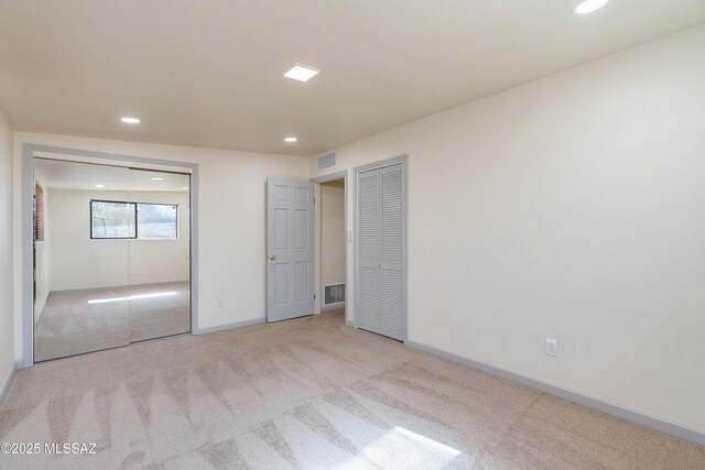 unfurnished room featuring recessed lighting, light carpet, and baseboards