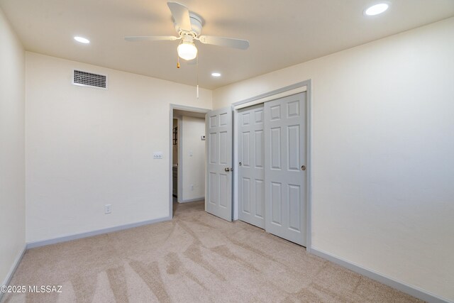 carpeted empty room with a ceiling fan, baseboards, and recessed lighting