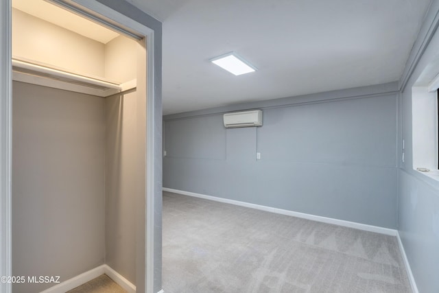 basement featuring light carpet and a wall mounted AC