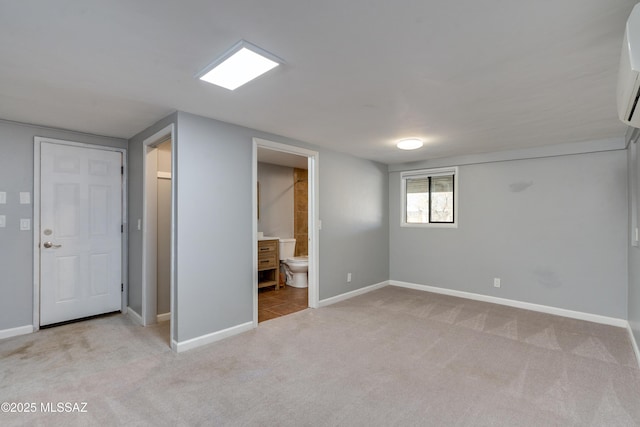 basement with a wall mounted AC and light carpet