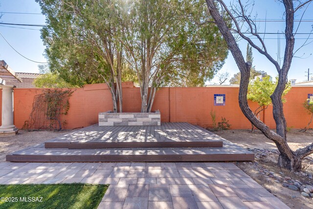 rear view of property featuring brick siding and a patio area