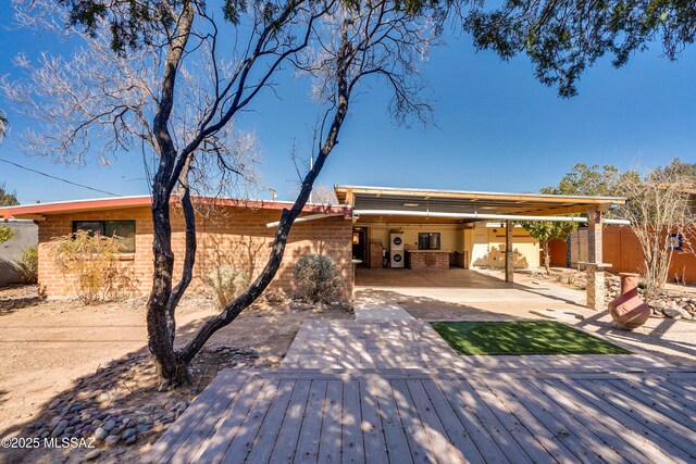 view of patio featuring a fenced backyard and a deck