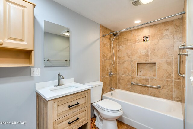 bathroom featuring a tile shower, toilet, vanity, and visible vents
