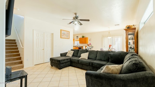 tiled living room featuring ceiling fan