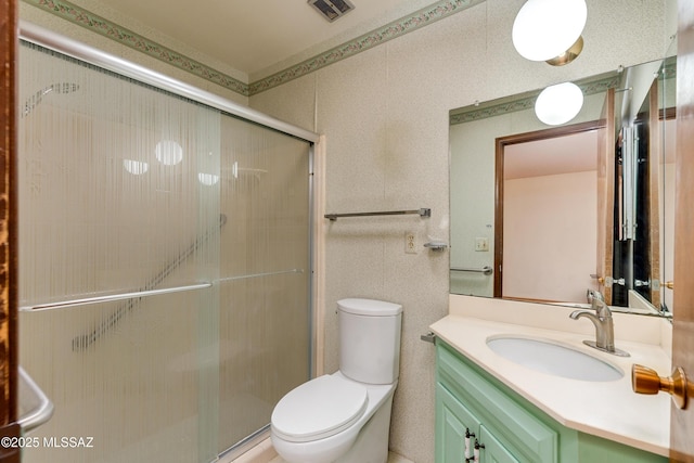 bathroom with toilet, an enclosed shower, and vanity