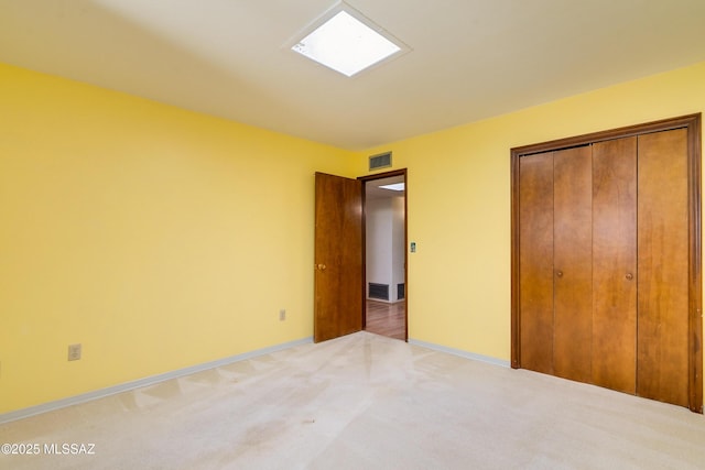 unfurnished bedroom with a closet and carpet flooring