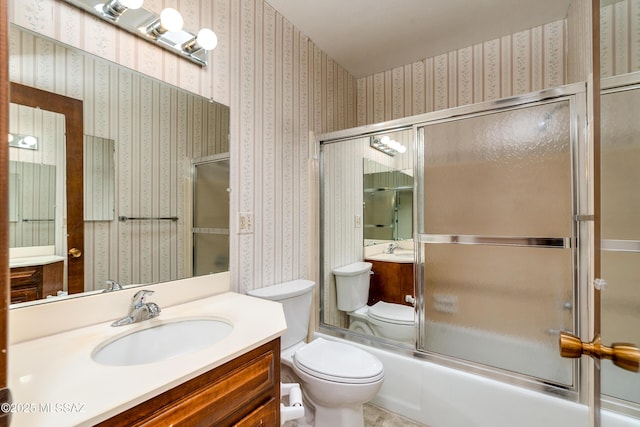 full bathroom with toilet, enclosed tub / shower combo, and vanity