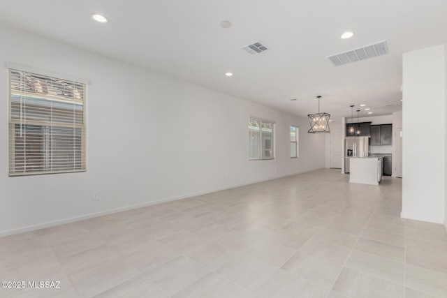 unfurnished living room featuring light tile patterned flooring