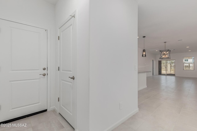 hallway with light tile patterned floors