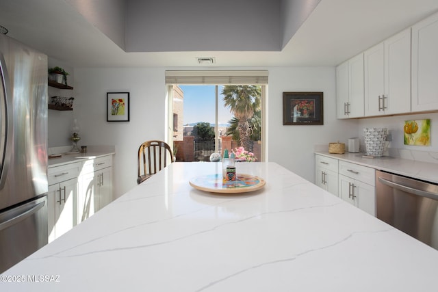 dining space with a raised ceiling