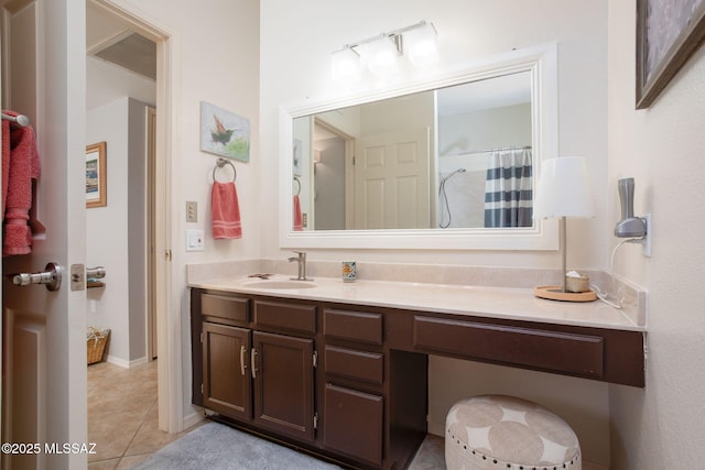 bathroom with a shower with shower curtain, tile patterned floors, and vanity