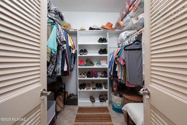 spacious closet with light tile patterned floors