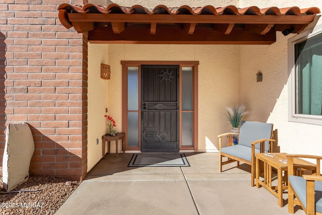 property entrance featuring a patio area