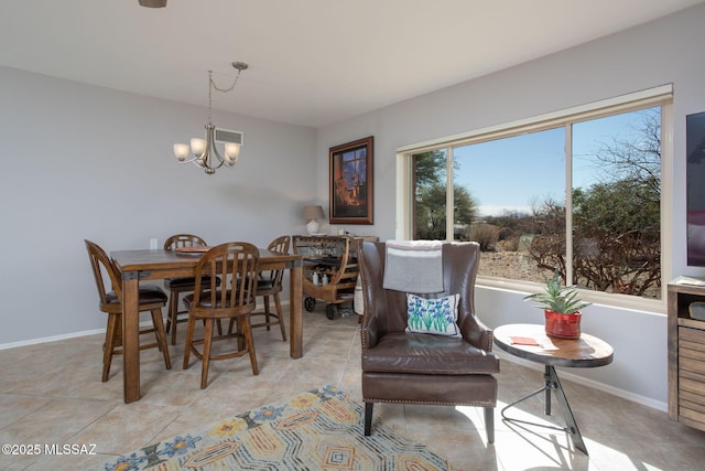 dining space featuring light tile patterned floors and a notable chandelier