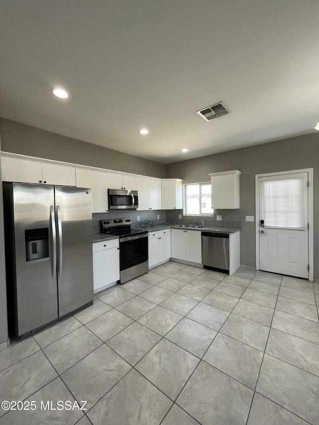 kitchen with white cabinetry and appliances with stainless steel finishes