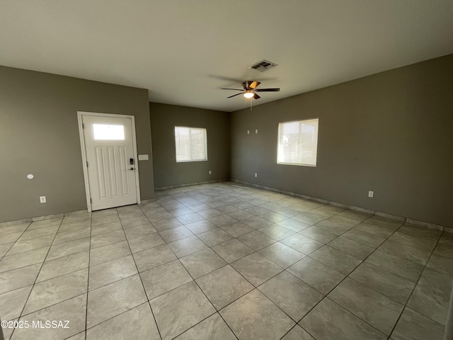 tiled entryway with ceiling fan