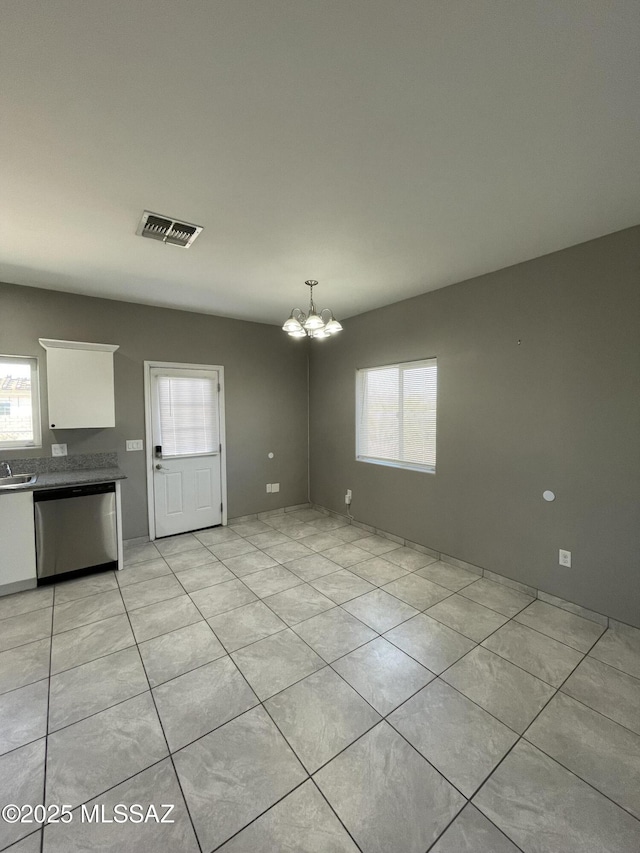 interior space with light tile patterned flooring, sink, and a notable chandelier