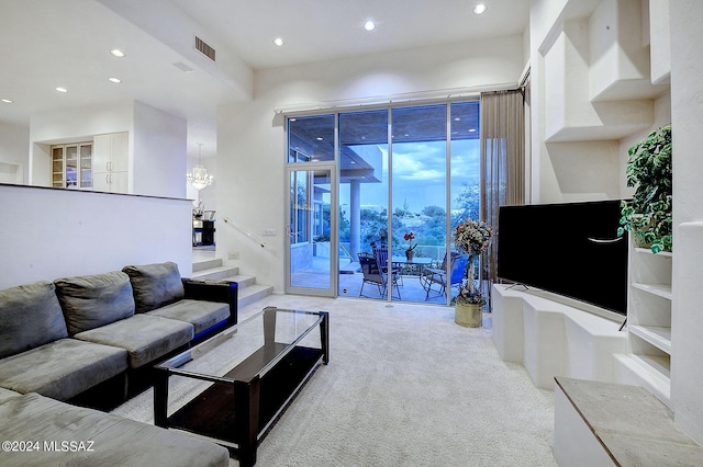 living room featuring light carpet and an inviting chandelier