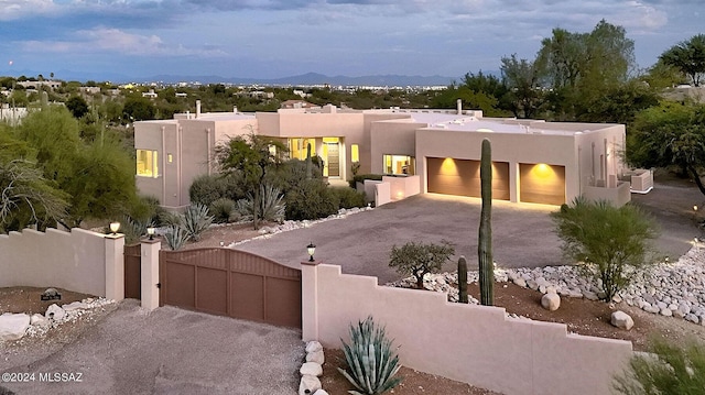 southwest-style home with a garage and a mountain view