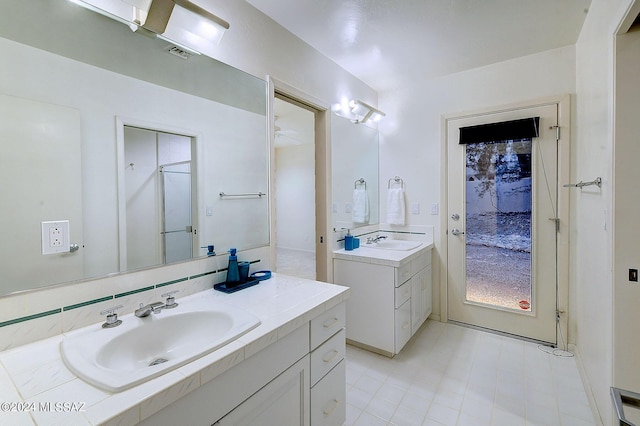 bathroom with a shower and vanity