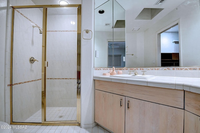 bathroom featuring walk in shower and vanity