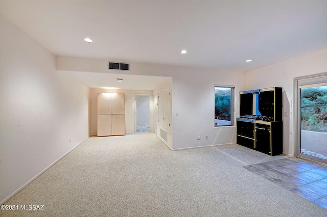 unfurnished living room with light carpet