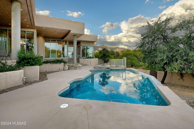 view of swimming pool featuring a mountain view and a patio area