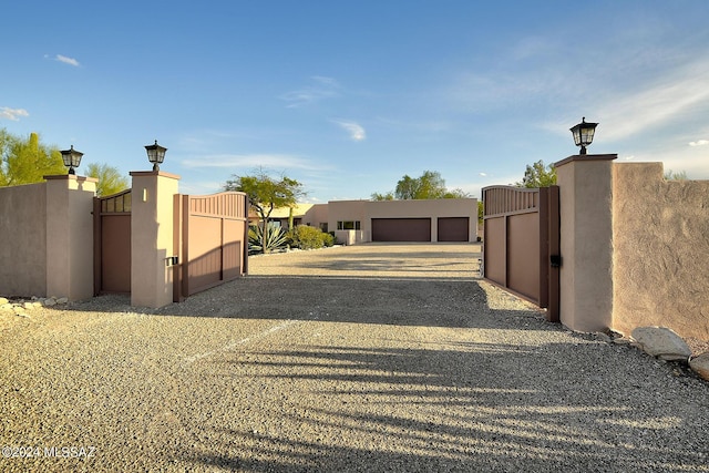 view of gate with a garage