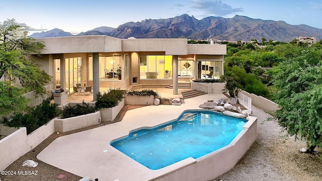 view of pool featuring a patio area and a mountain view