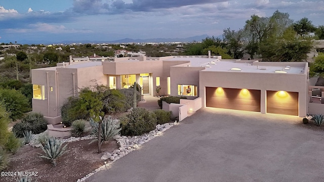 southwest-style home featuring a garage and a mountain view