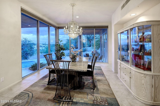 tiled dining room with a wall of windows and a notable chandelier