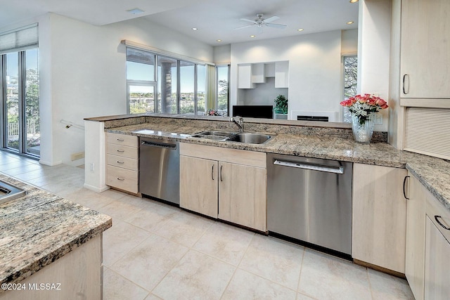 kitchen featuring light stone countertops, sink, stainless steel dishwasher, and ceiling fan