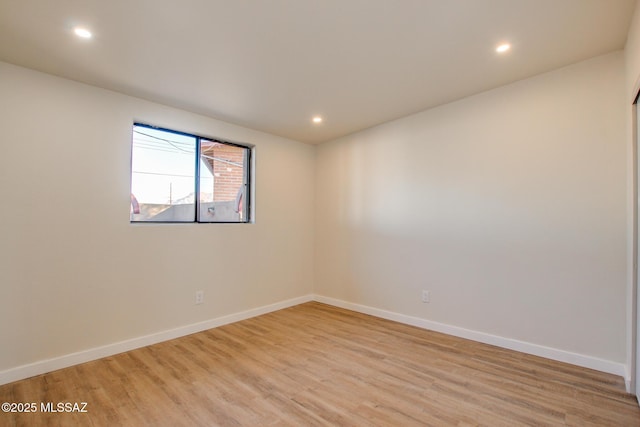 spare room featuring light wood-type flooring