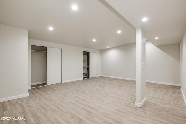 basement with light hardwood / wood-style floors